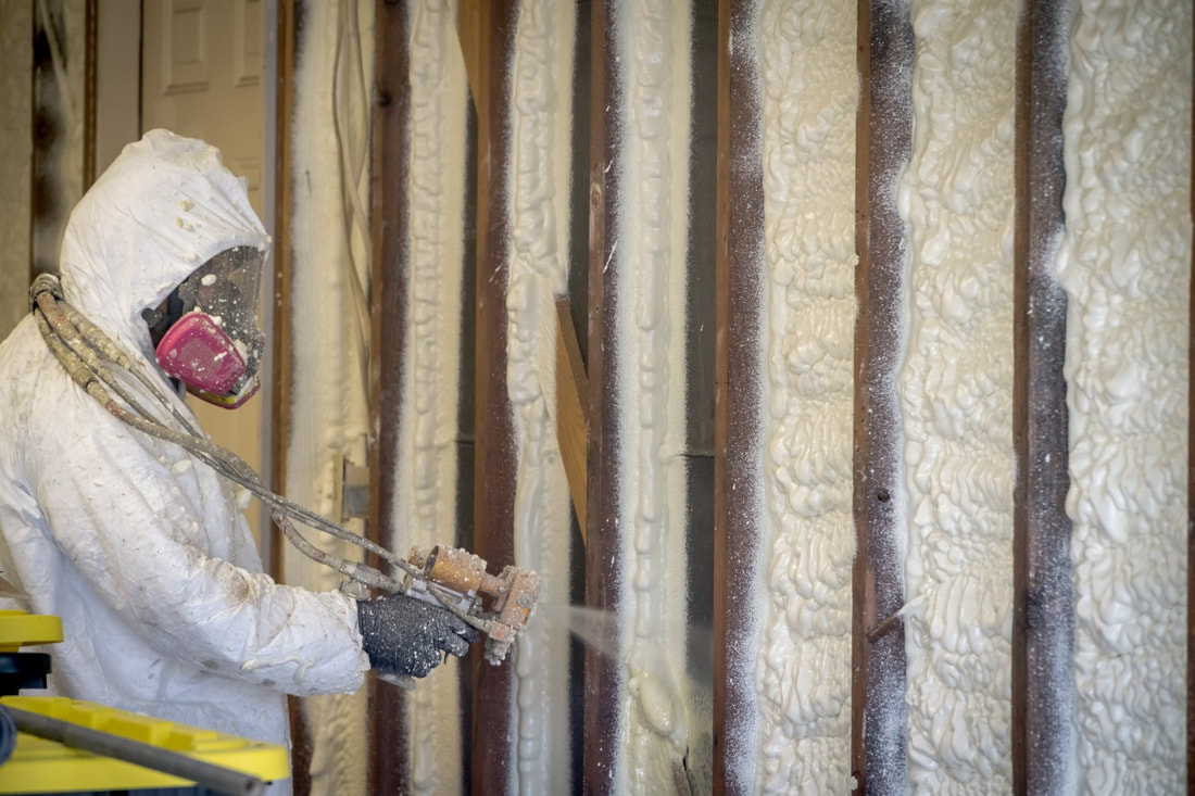 An image of a person working on a spray foam insulation 