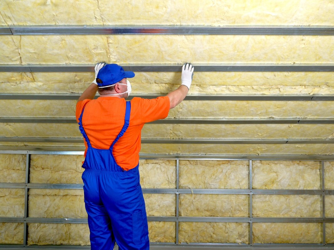 A picture of a person working on an attic insulation service